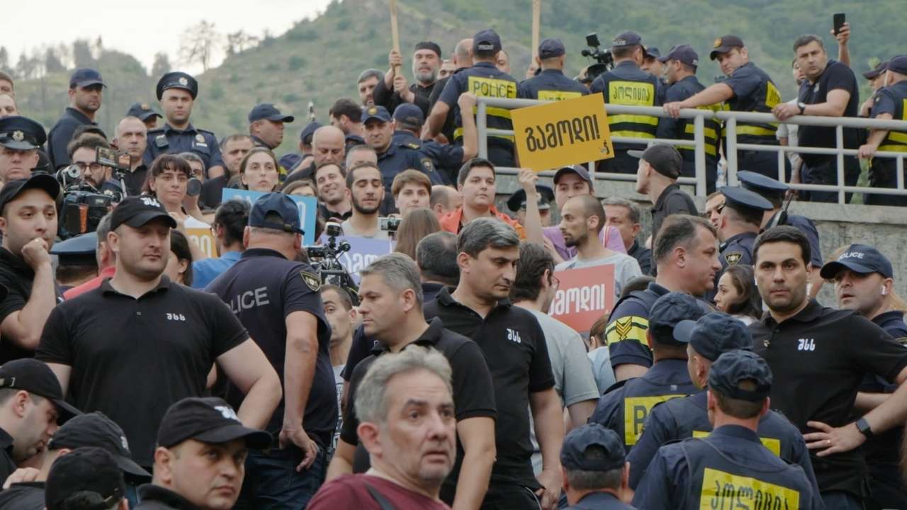 Crowd of people holding signs